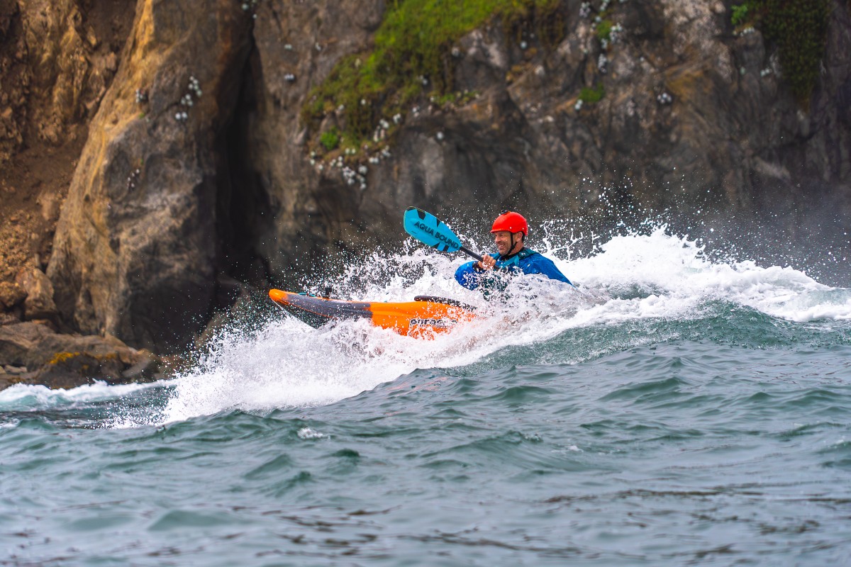 kayaking on a wave at sea