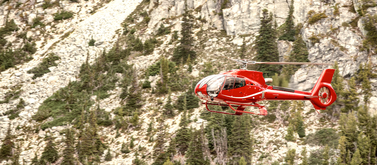 Red rescue helicopter in a mountain operation