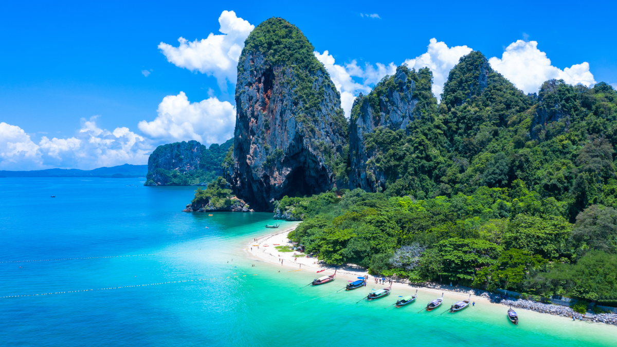 Phra Nang Cave Beach with traditional long tail boat on Ao Phra Nang Beach, Railay Bay, Krabi, Thailand.