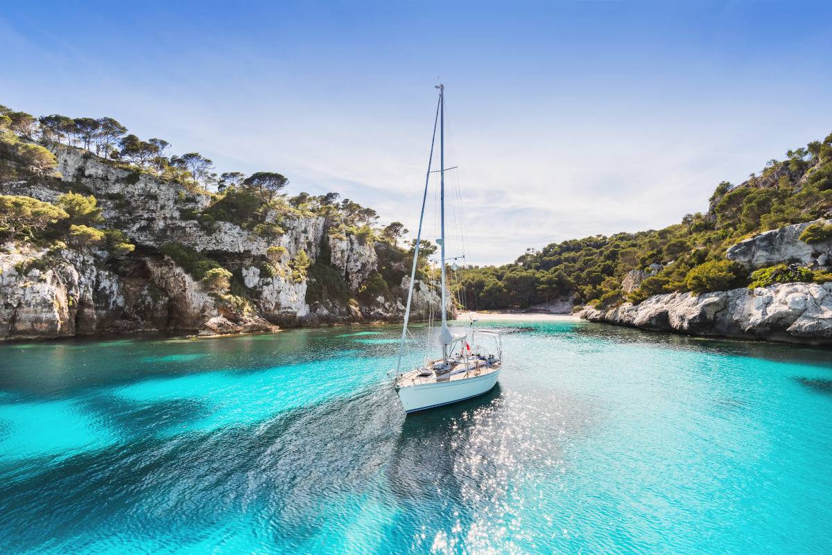 Beautiful beach with sailing boat yacht