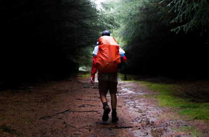Hiker walking down trail.