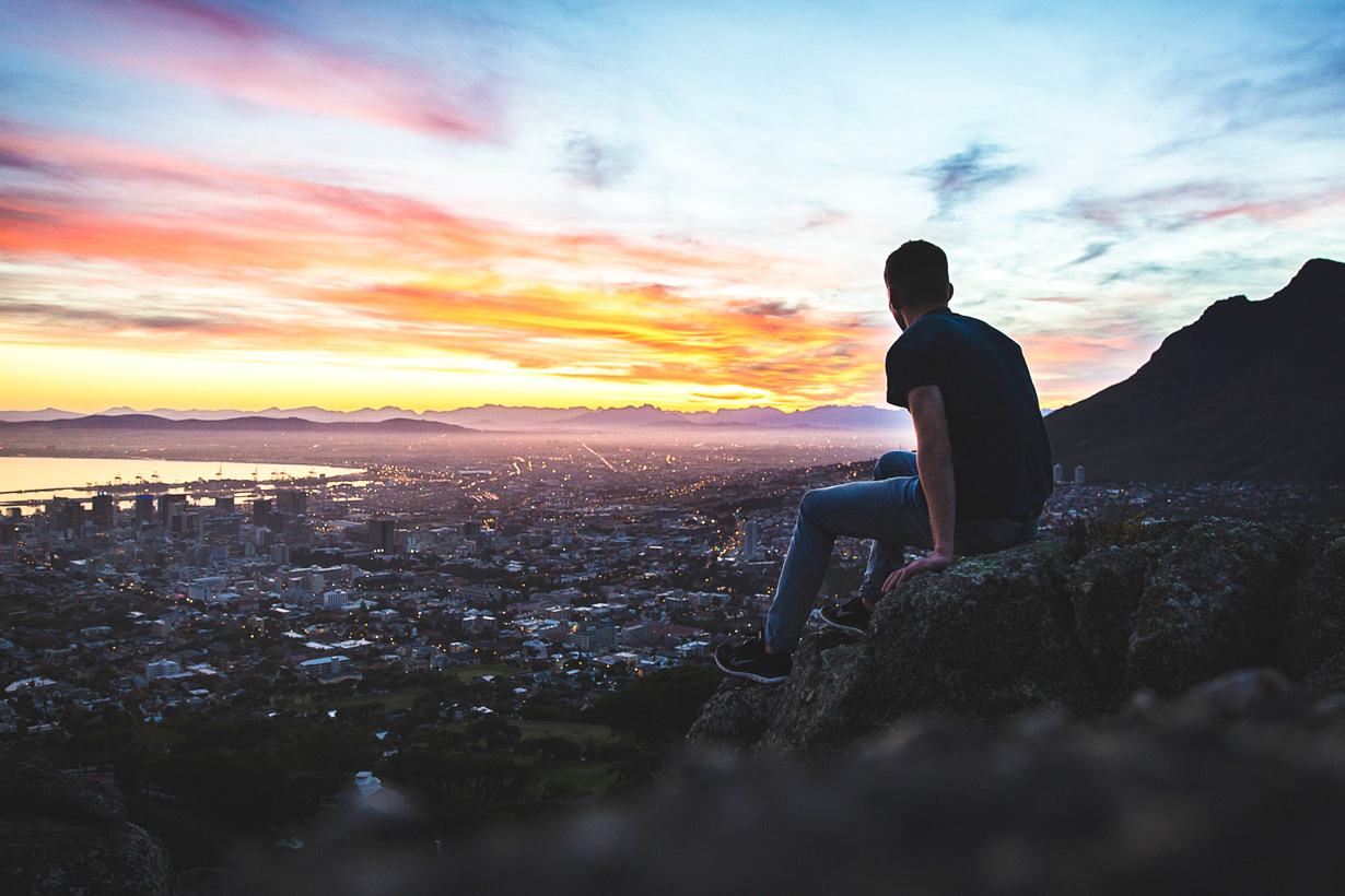 Man sits on rock to overlook Cape Town, South Africa