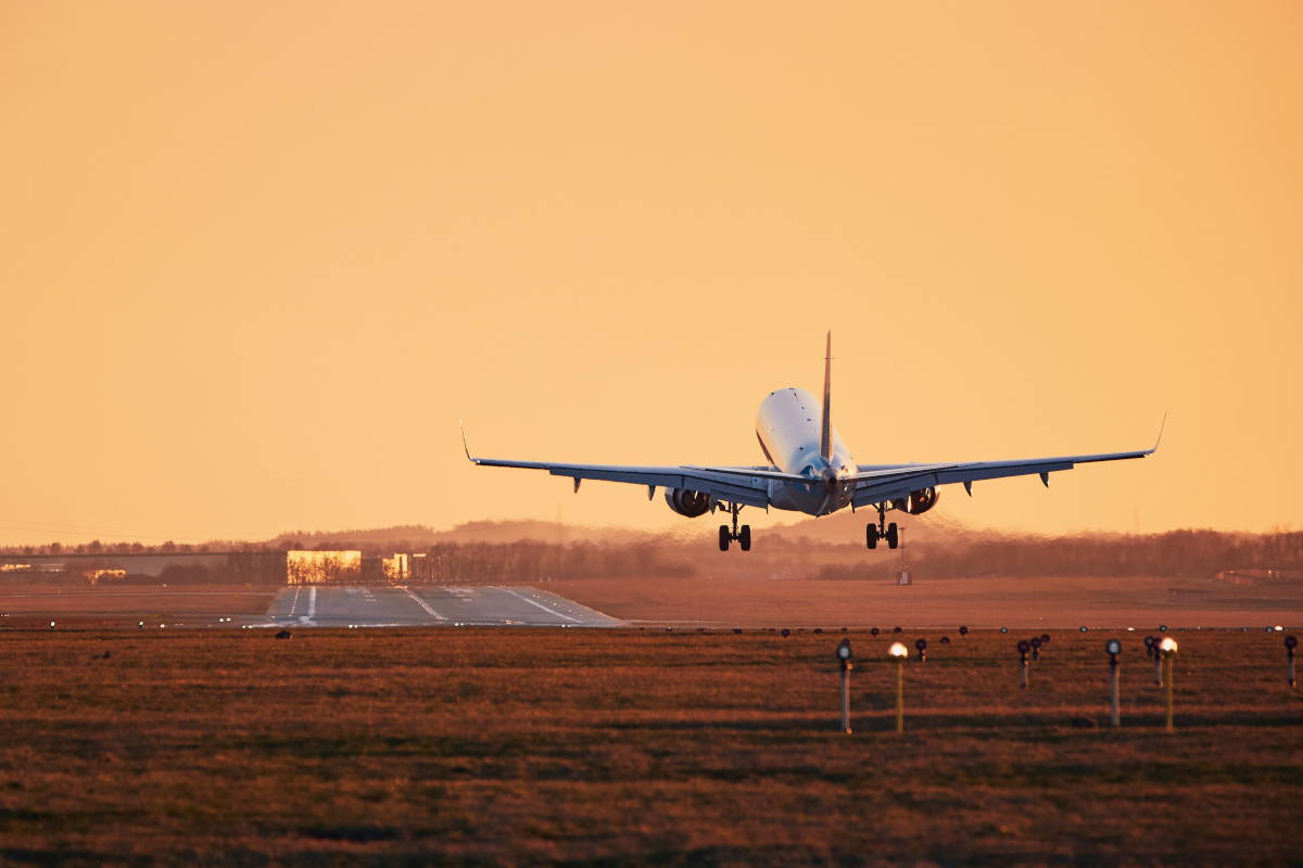 Airplane landing at sunset